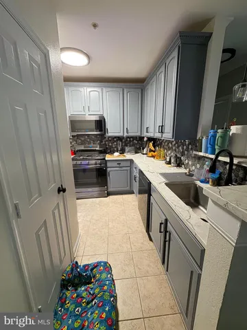 a kitchen with a sink cabinets and a window