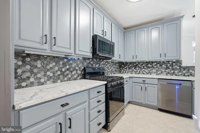 a kitchen with stainless steel appliances granite countertop a refrigerator stove and sink