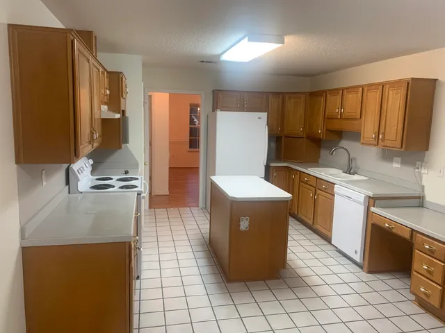 a kitchen with a sink appliances and cabinets