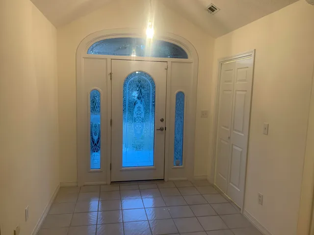a view of a hallway with brick walls