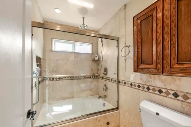 a bathroom with a shower a mirror and a shower