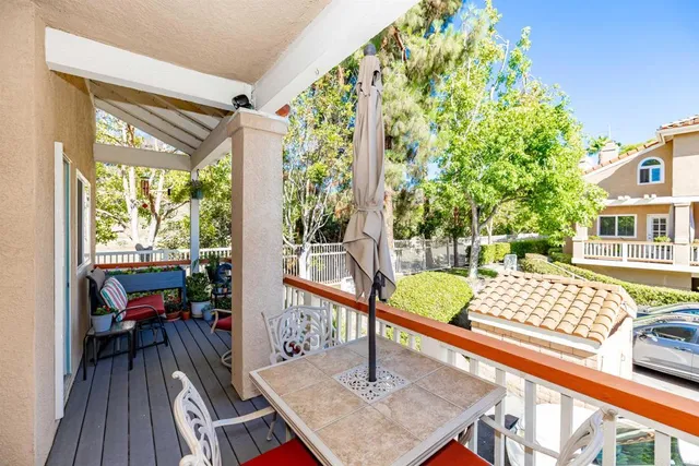 a view of balcony with wooden floor and outdoor seating