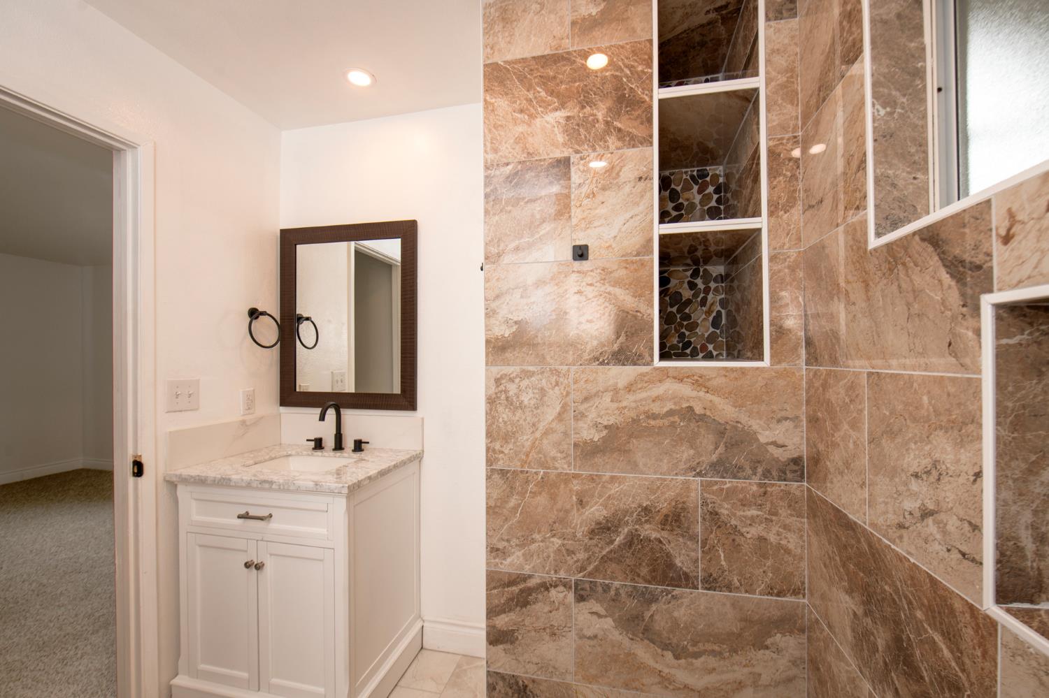5167 East Dwight Way Fresno, CA 93727 - Photo 12 of 30 a bathroom with a sink and a mirror