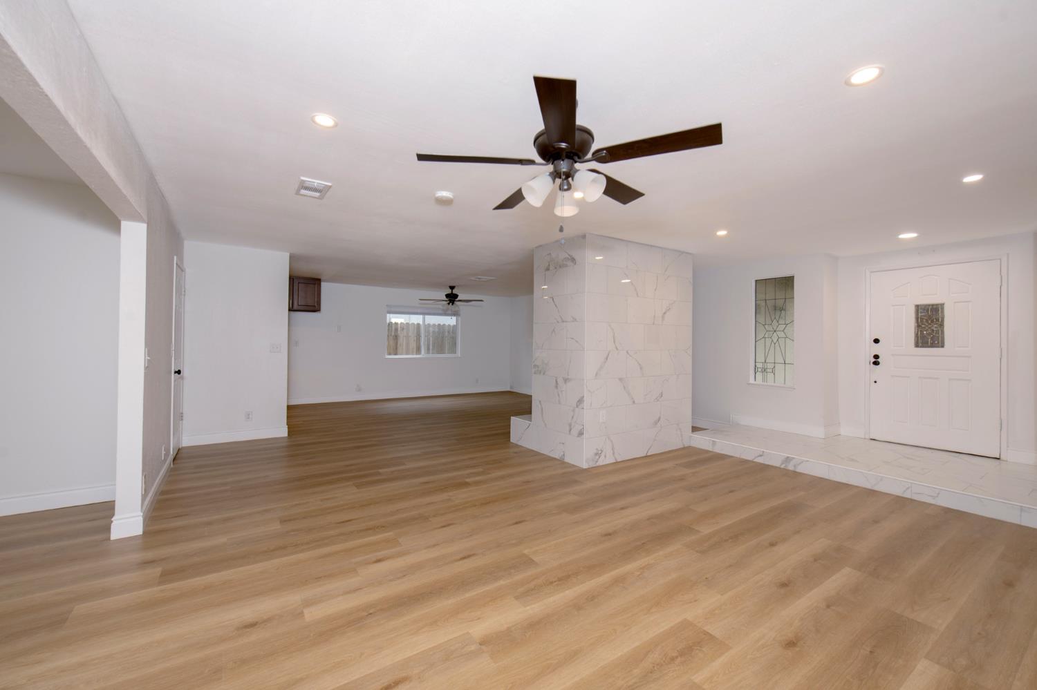 5167 East Dwight Way Fresno, CA 93727 - Photo 14 of 30 a view of empty room with wooden floor and fan