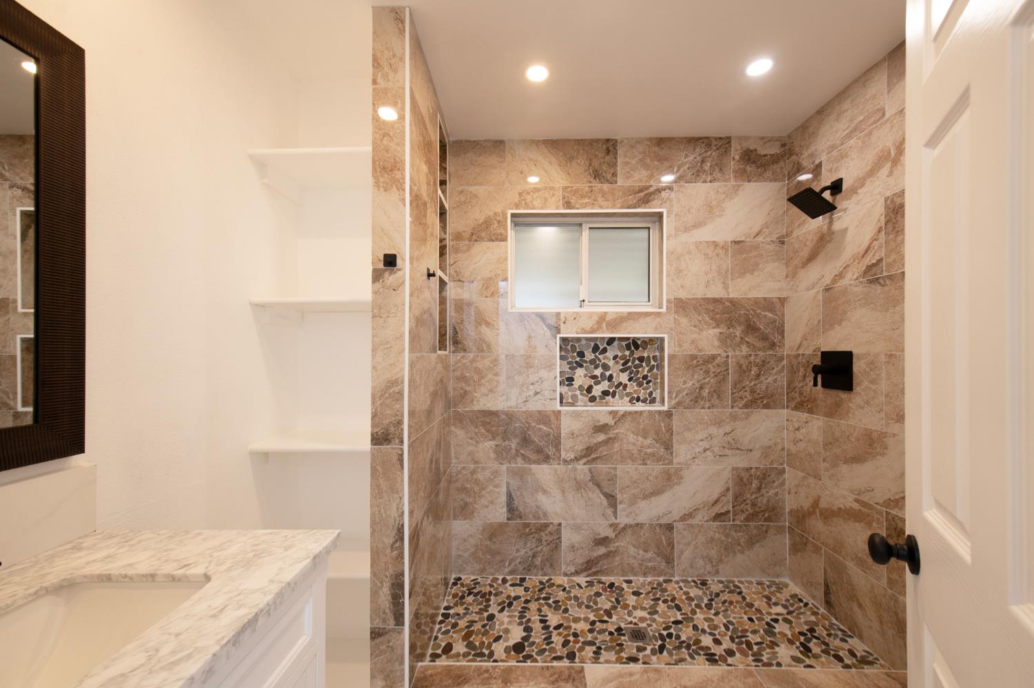 5167 East Dwight Way Fresno, CA 93727 - Photo 17 of 30 a bathroom with a granite countertop shower a sink and a shower