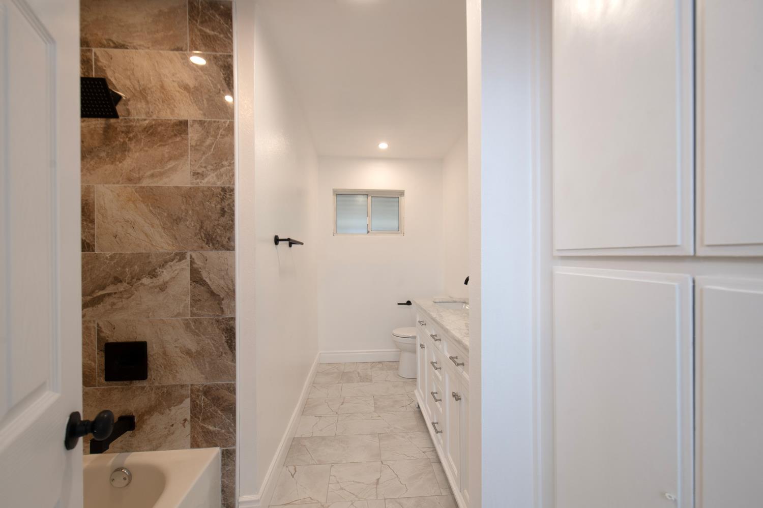 5167 East Dwight Way Fresno, CA 93727 - Photo 18 of 30 a bathroom with a sink and a mirror