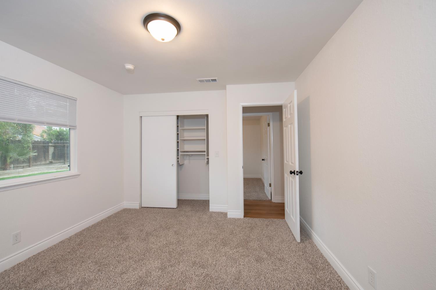 5167 East Dwight Way Fresno, CA 93727 - Photo 19 of 30 an empty room with windows and closet