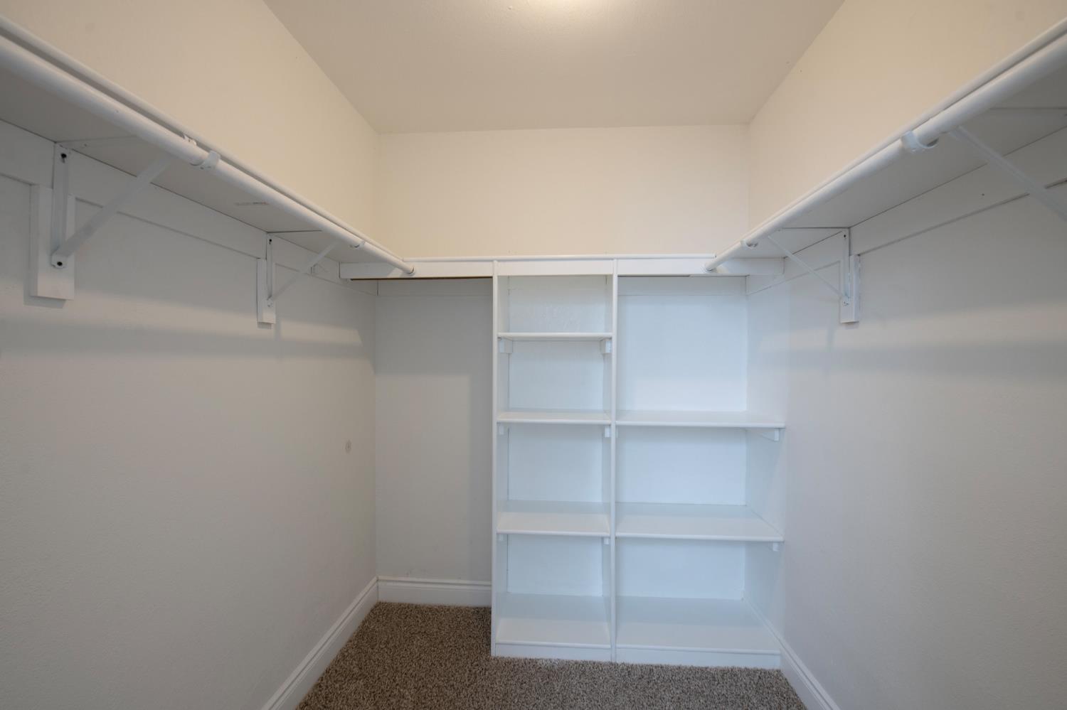5167 East Dwight Way Fresno, CA 93727 - Photo 22 of 30 a view of walk in closet with empty racks