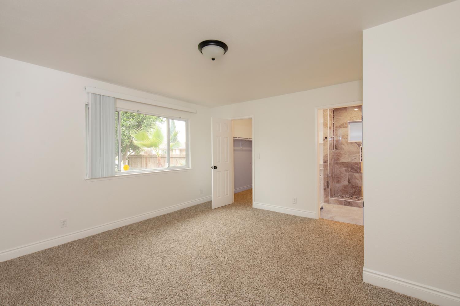 5167 East Dwight Way Fresno, CA 93727 - Photo 23 of 30 an empty room with windows