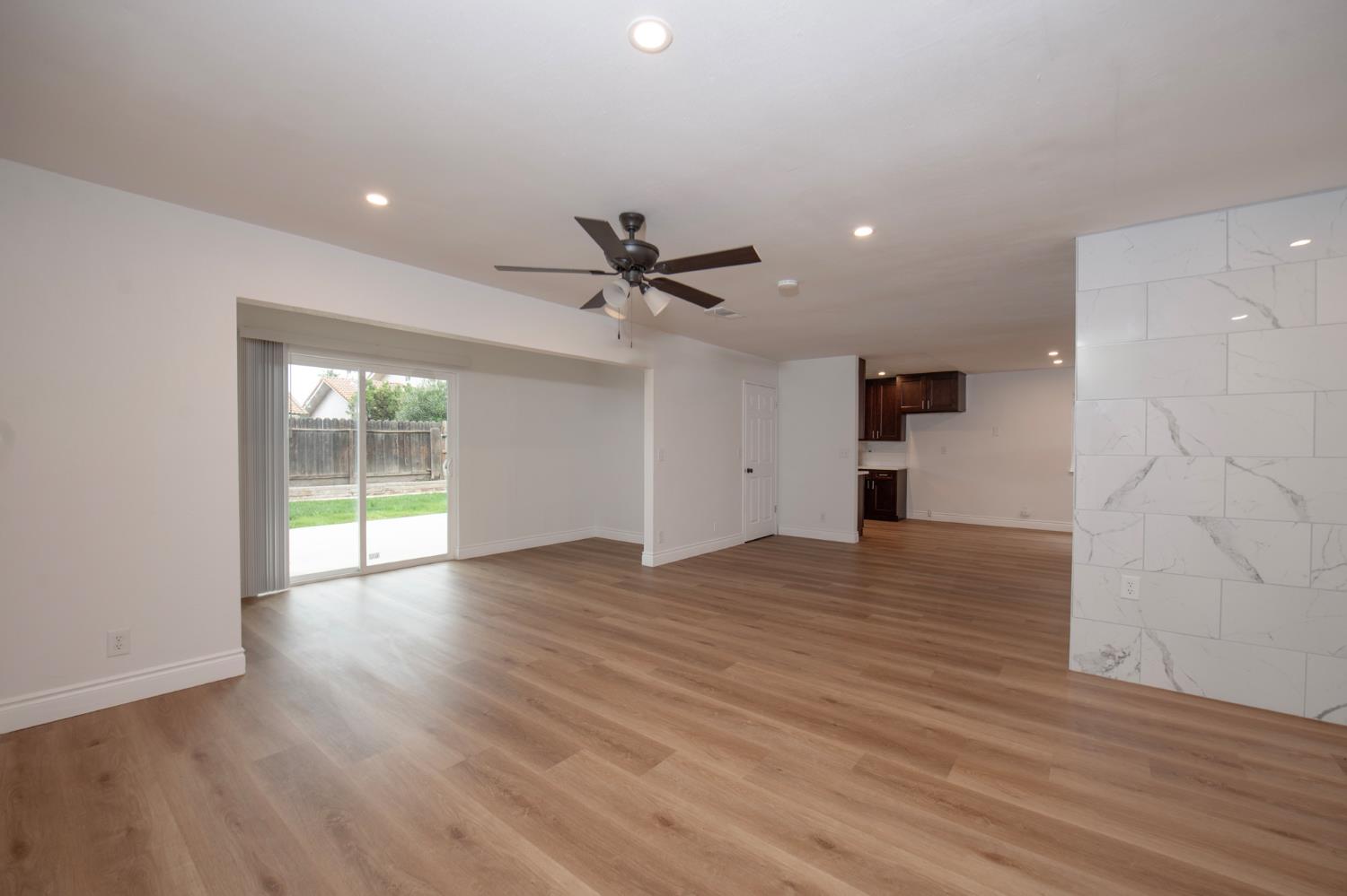 5167 East Dwight Way Fresno, CA 93727 - Photo 3 of 30 a view of empty room with wooden floor and ceiling fan