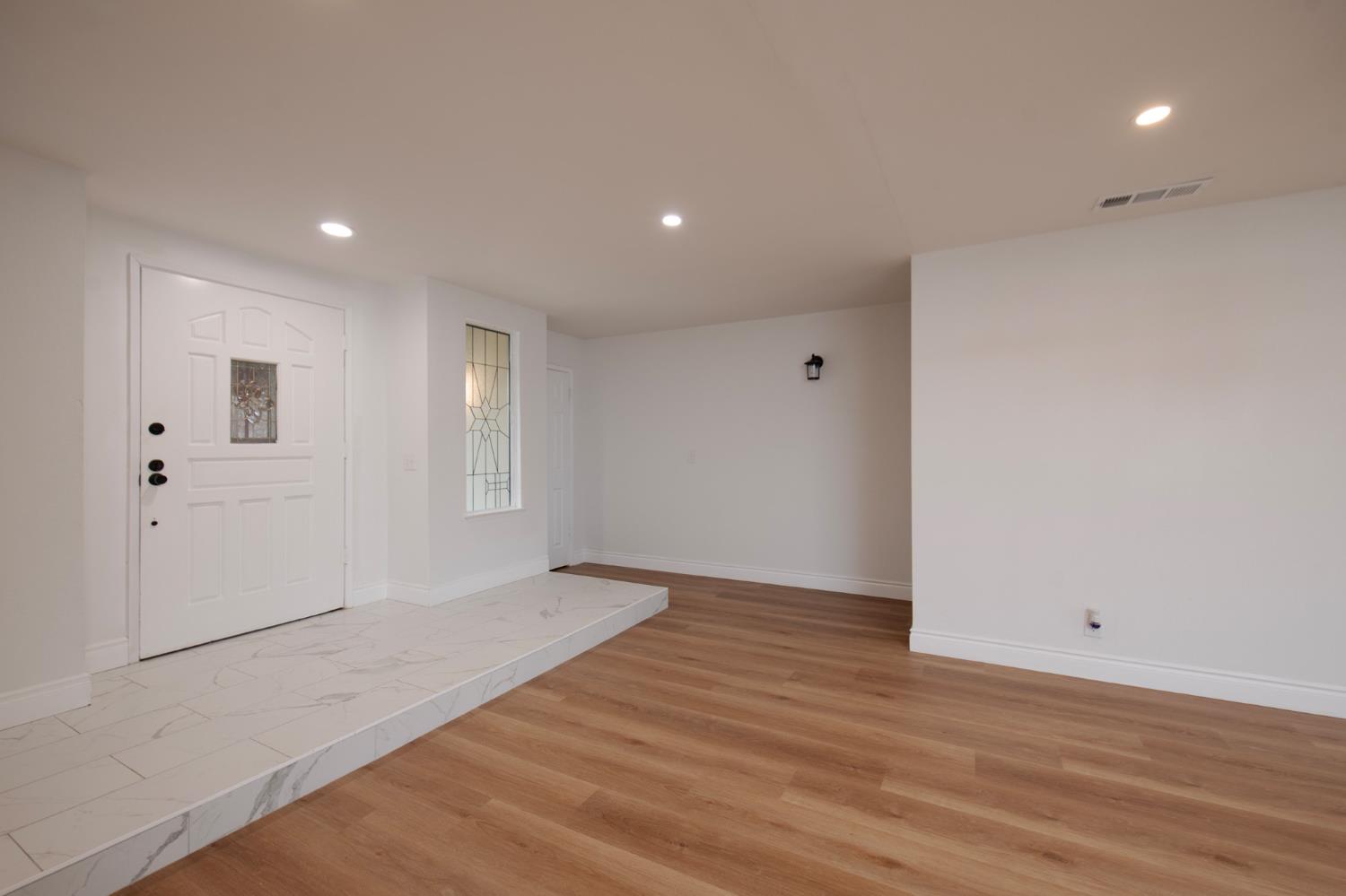 5167 East Dwight Way Fresno, CA 93727 - Photo 10 of 30 a view of an empty room with wooden floor