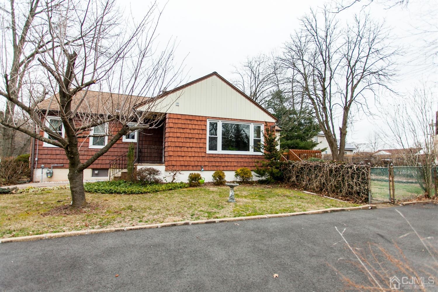 111 Alfred Street Edison, NJ 08820 - Photo 1 of 15 a view of a house with a yard covered in snow
