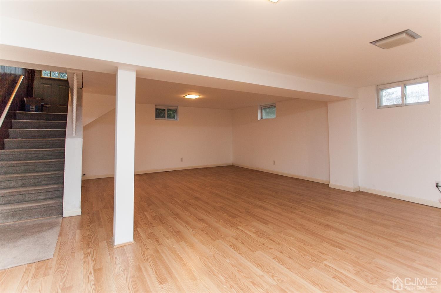 111 Alfred Street Edison, NJ 08820 - Photo 13 of 15 a view of empty room with wooden floor and fan