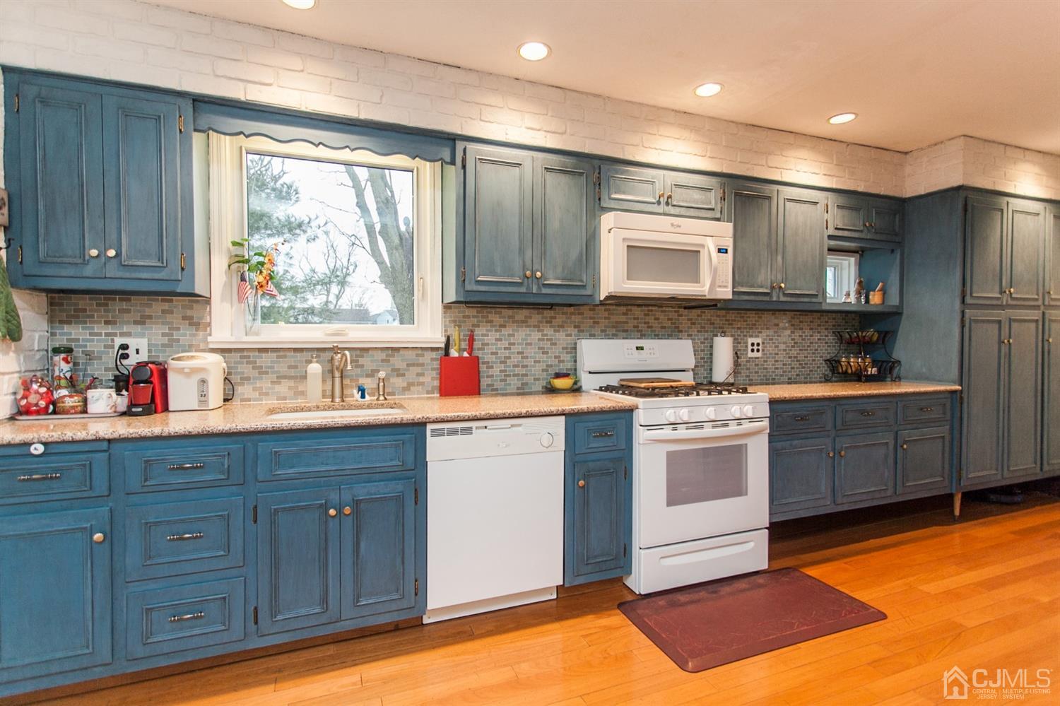 111 Alfred Street Edison, NJ 08820 - Photo 5 of 15 a kitchen with kitchen island granite countertop wooden cabinets stainless steel appliances a sink and a window