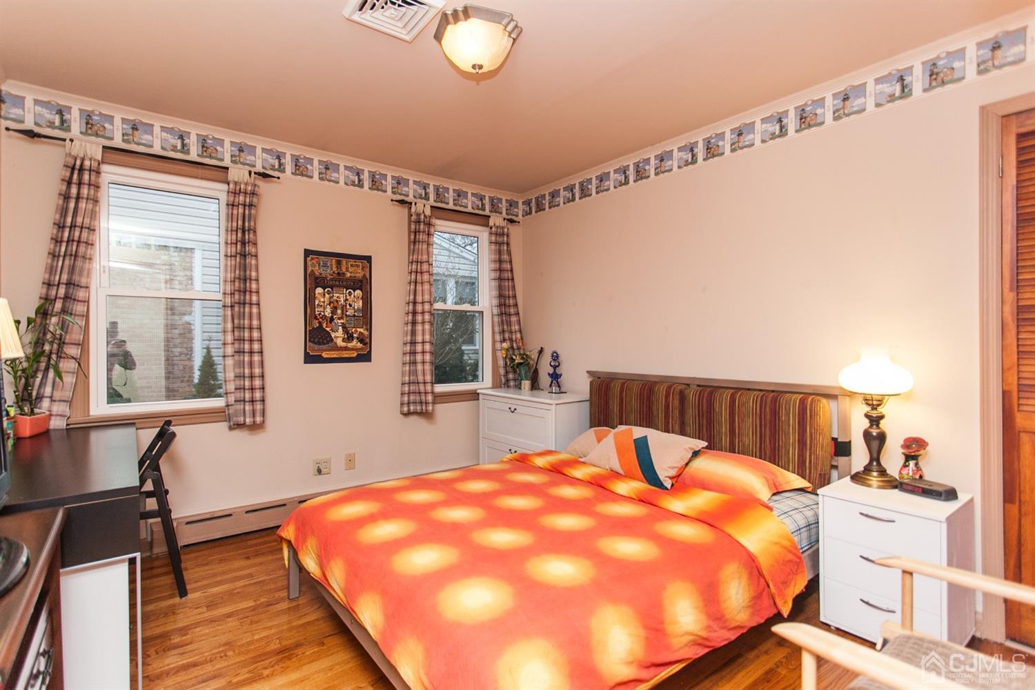 111 Alfred Street Edison, NJ 08820 - Photo 9 of 15 a bed sitting in a bedroom next to a window
