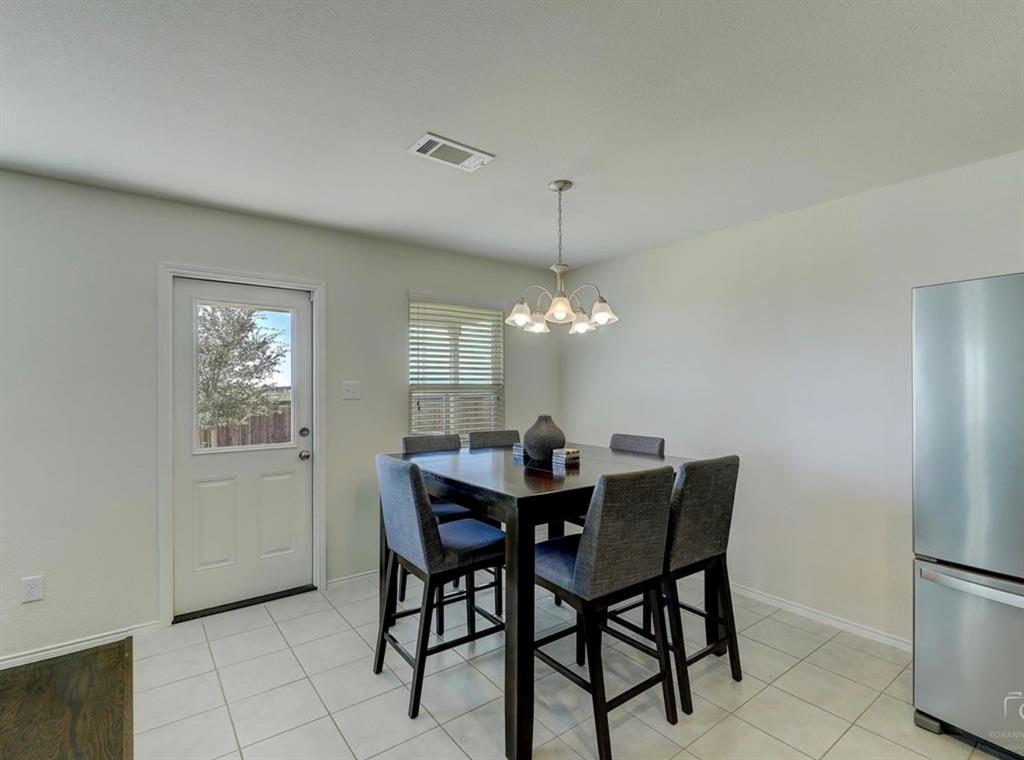 2207 Heaton Street Forney, TX 75126 - Photo 12 of 25 Dining area featuring tile flooring, a window with blinds, and a permanent ceiling light fixture