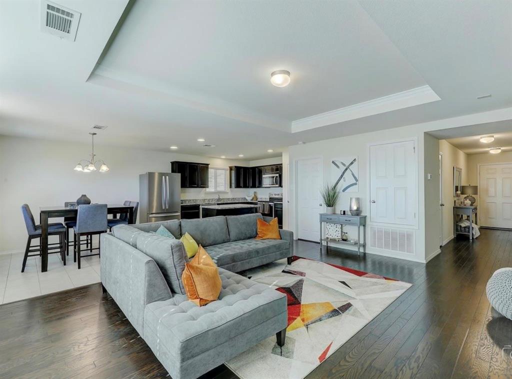 2207 Heaton Street Forney, TX 75126 - Photo 5 of 25 Open-concept living area featuring dark wood-finish flooring, a tray ceiling, and recessed lighting