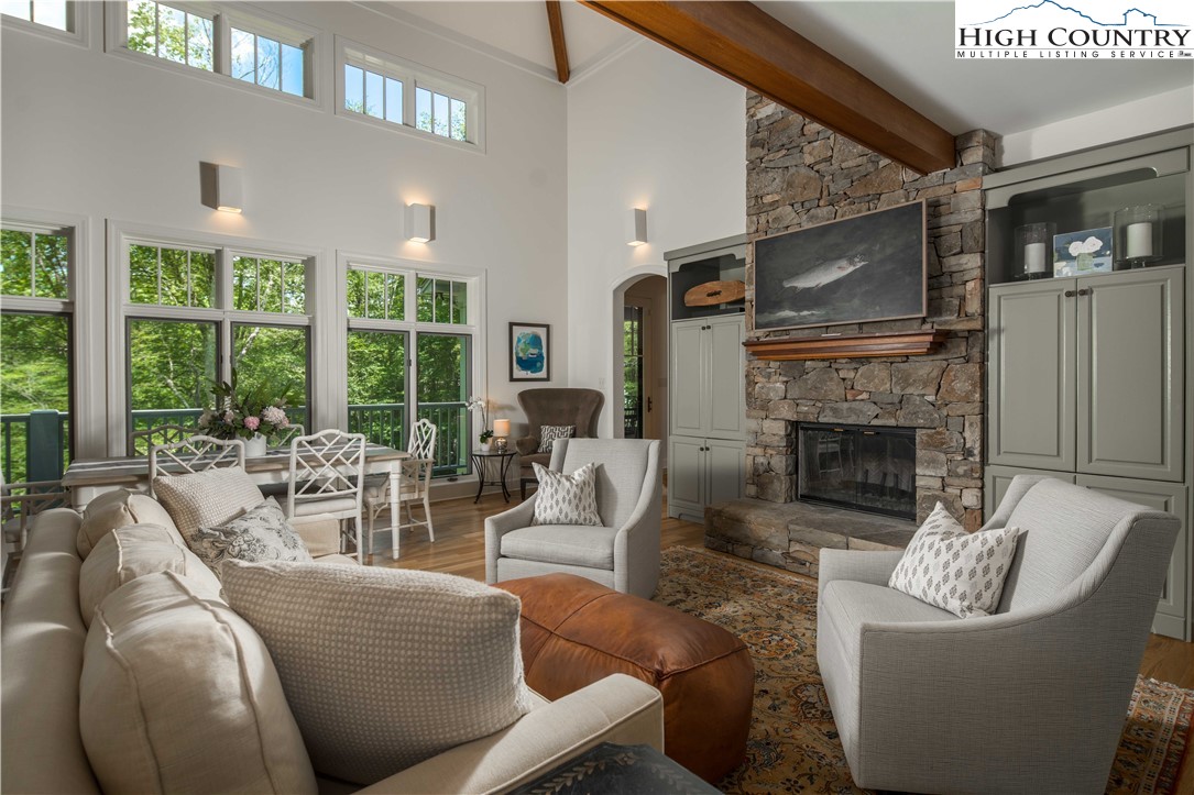 509 Twin Rivers Drive Boone, NC 28607 - Photo 14 of 50 a living room with furniture a large window and a fireplace