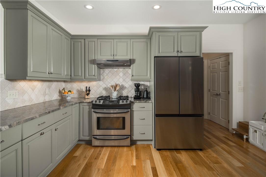 509 Twin Rivers Drive Boone, NC 28607 - Photo 18 of 50 a kitchen with a refrigerator and a stove top oven