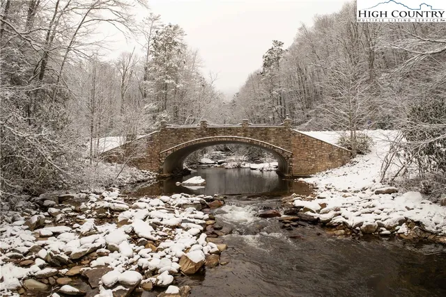 a living room with furniture and large windows
