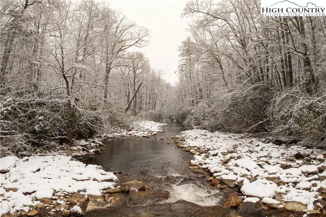 a living room with furniture wooden floor and a table