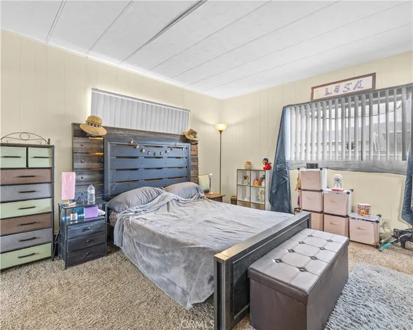 a bed room with a bed and a television