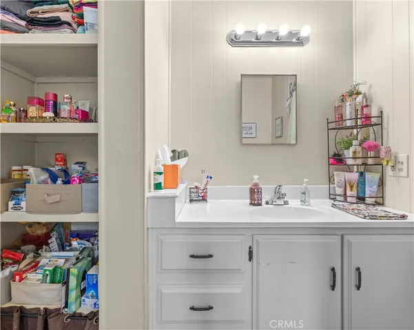 a bathroom with a sink mirror and vanity