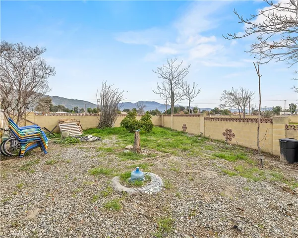 a view of a yard with wooden fence