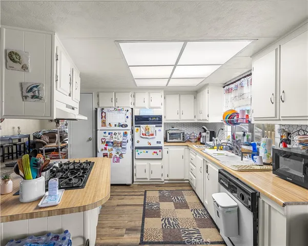 a kitchen with a sink cabinets and window