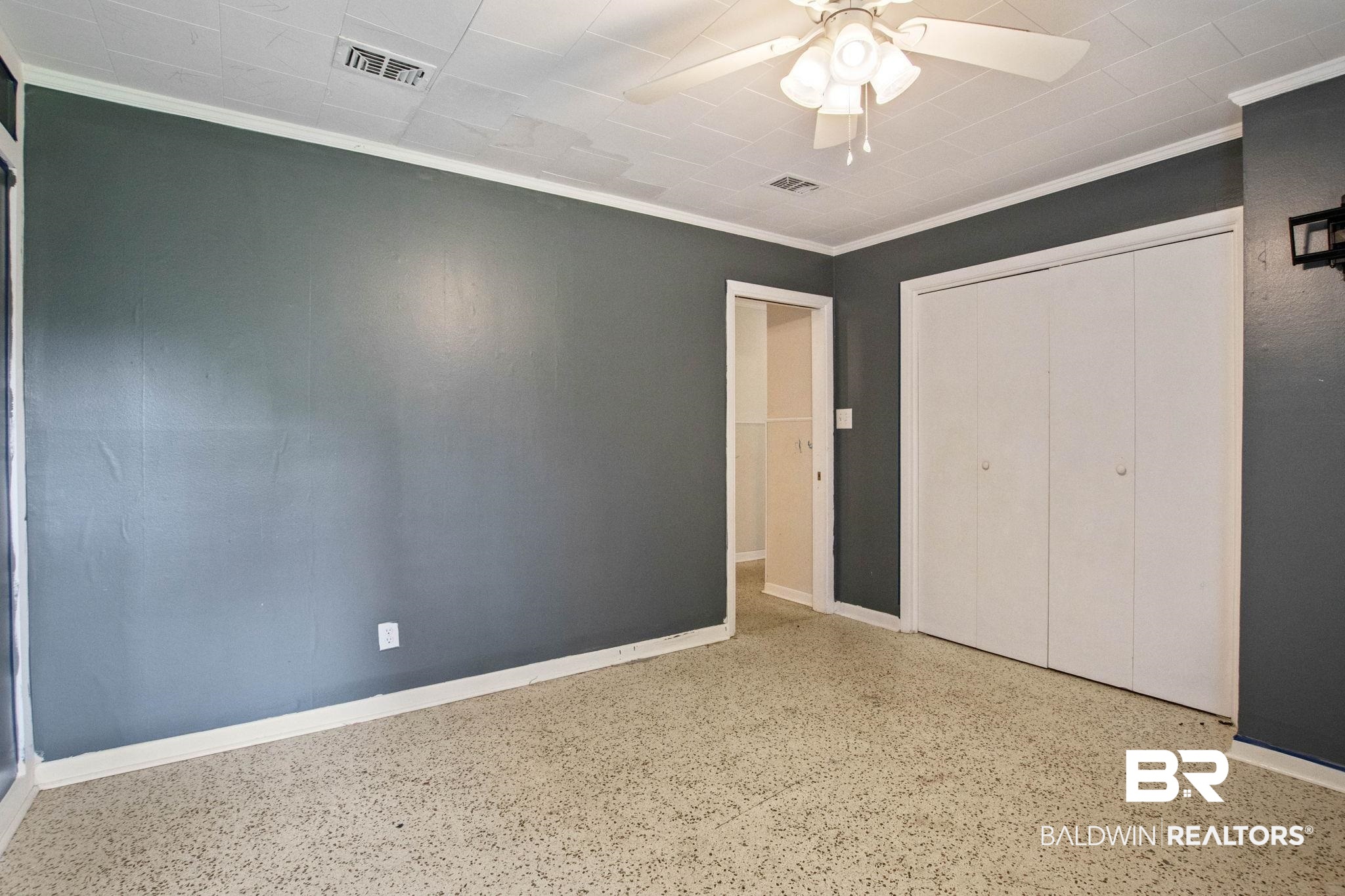 384 Old Bratt Road Atmore, AL 36502 - Photo 47 of 64 Room featuring textured flooring, a ceiling fan with integrated lighting, and white bi-fold closet doors