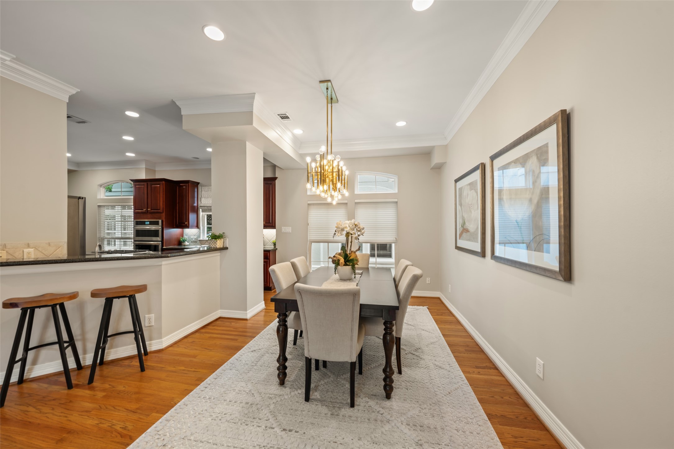 2708 Wroxton Road West University Place, TX 77005 - Photo 13 of 22 Discover the elegant bar and dining spaces, beautifully illuminated by natural light from expansive windows.