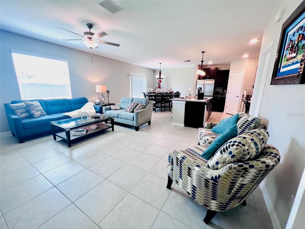 2170 Shining Azul Way Lutz, FL 33558 - Photo 5 of 11 a living room with furniture and a chandelier