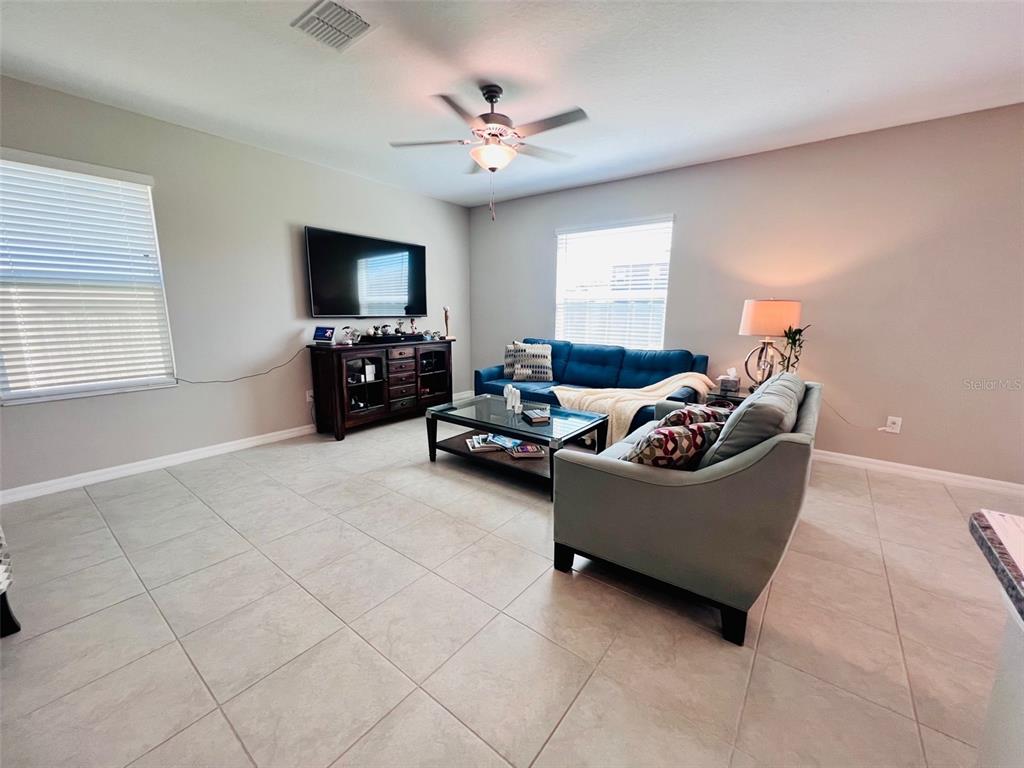2170 Shining Azul Way Lutz, FL 33558 - Photo 6 of 11 a living room with furniture and a ceiling fan
