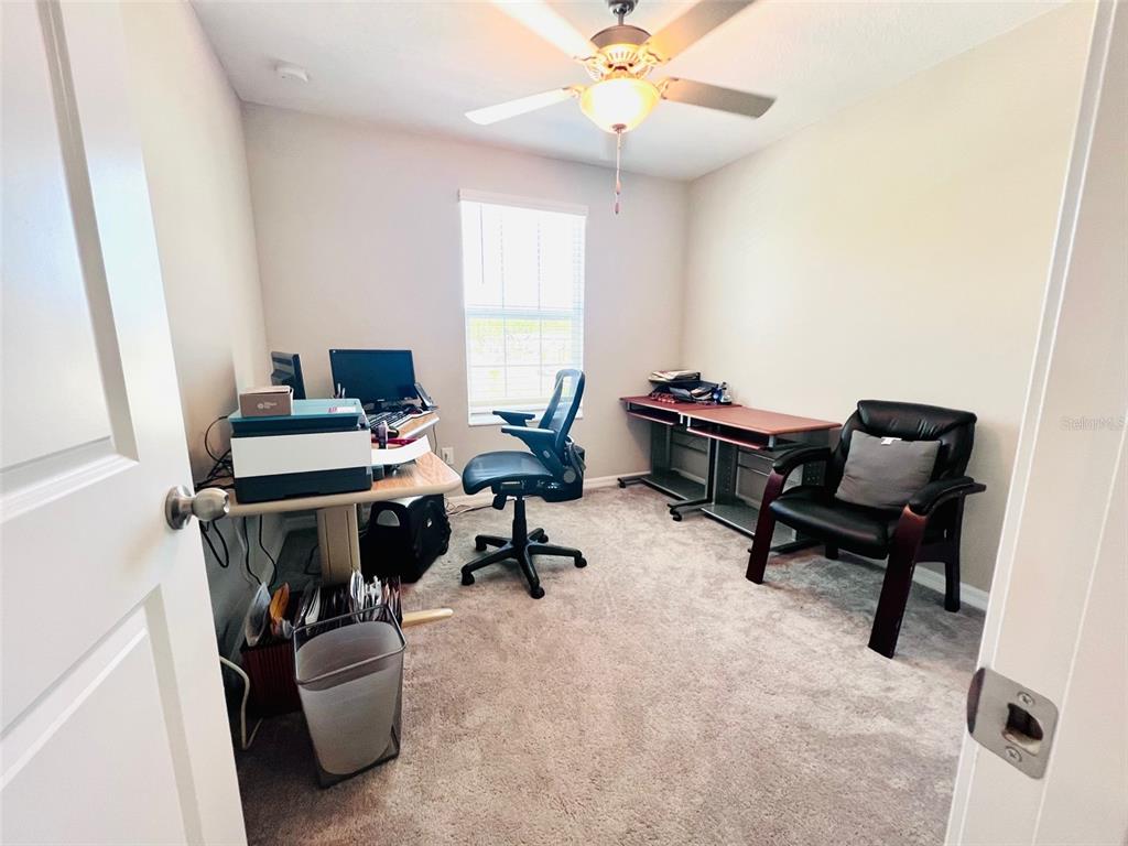 2170 Shining Azul Way Lutz, FL 33558 - Photo 8 of 11 a view of a workspace with furniture and a window