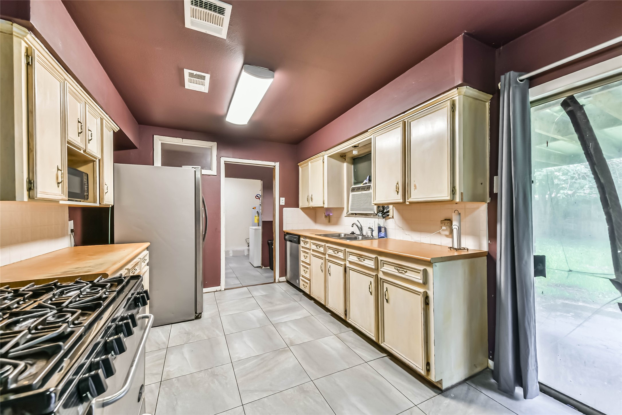 10438 Caxton Street Houston, TX 77016 - Photo 19 of 24 a kitchen with stainless steel appliances granite countertop a stove and a refrigerator