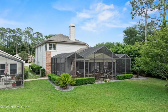 a swimming pool with outdoor seating and yard