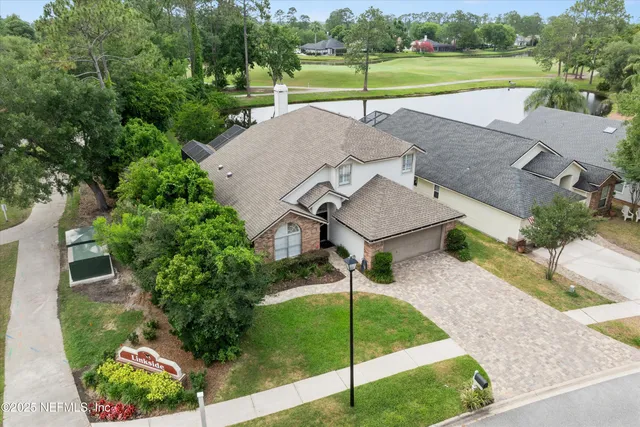 an aerial view of a house with a lake view
