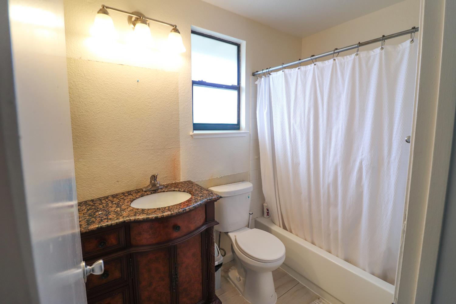 1188 Rio Royal Way Sacramento, CA 95834 - Photo 13 of 20 a bathroom with a granite countertop sink toilet and a mirror