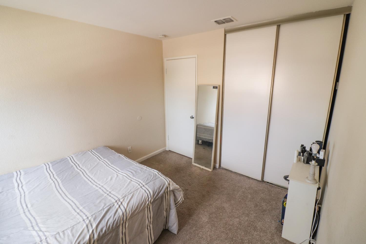 1188 Rio Royal Way Sacramento, CA 95834 - Photo 17 of 20 a bedroom with a bed and a mirror