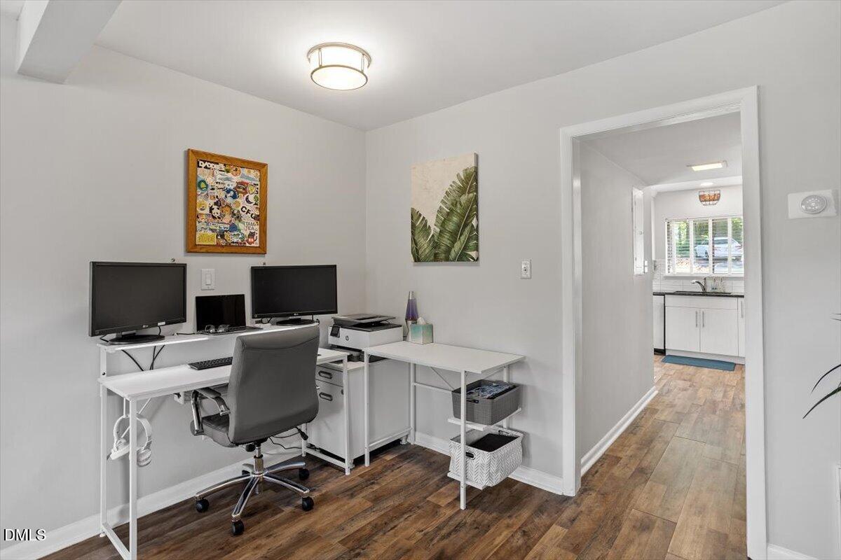 5045 Tall Pines Court Raleigh, NC 27609 - Photo 10 of 37 a view of a workspace with furniture and wooden floor