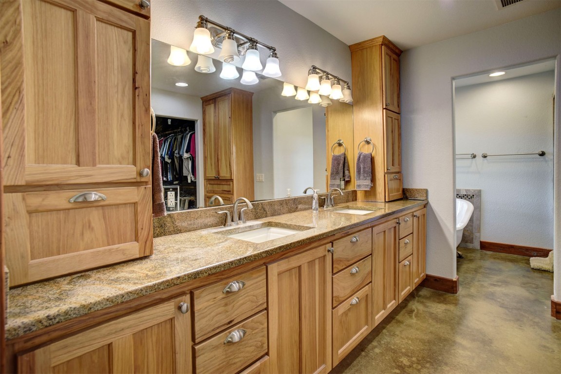 945 Justice Road West Point, TX 78963 - Photo 15 of 35 a spacious bathroom with a granite countertop sink a mirror and a shower