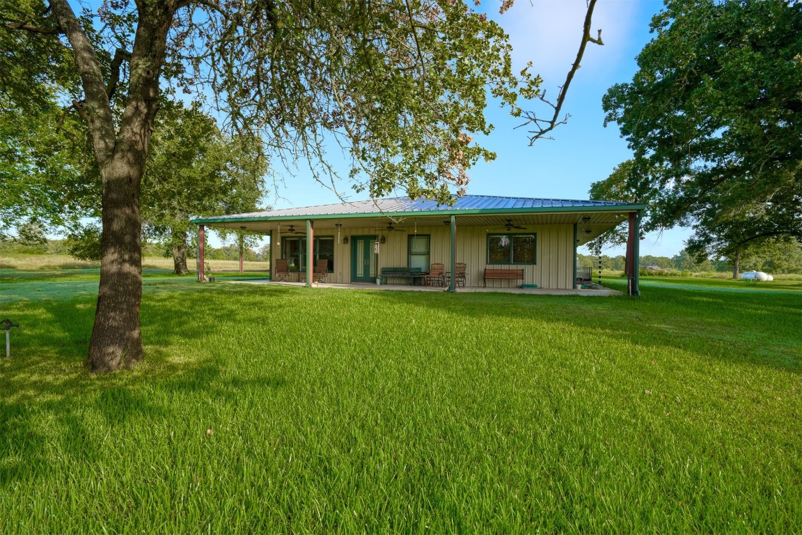 945 Justice Road West Point, TX 78963 - Photo 2 of 35 a front view of a house with a garden