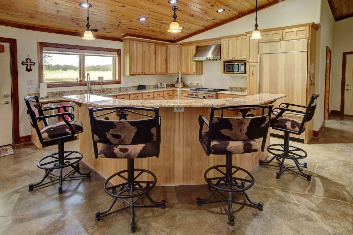 945 Justice Road West Point, TX 78963 - Photo 9 of 21 a kitchen with stainless steel appliances granite countertop wooden cabinets a dining table and chairs