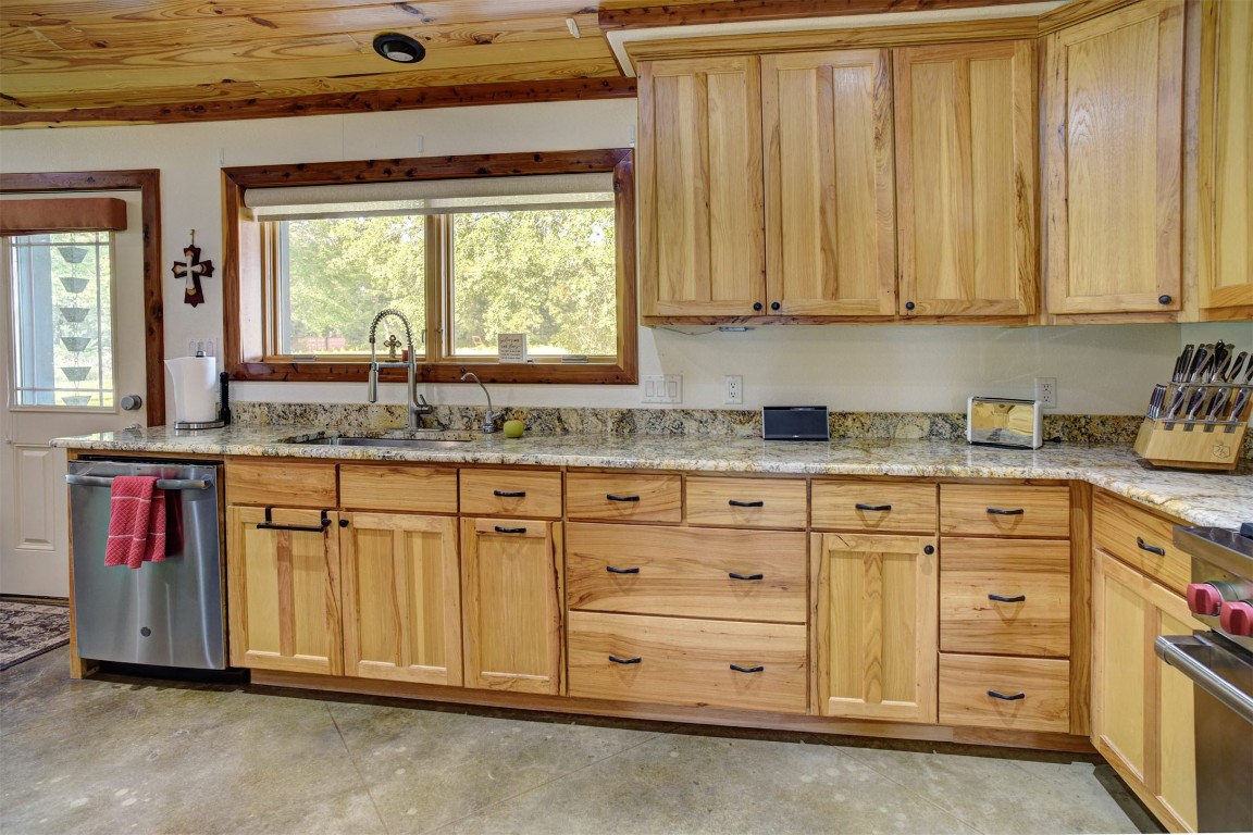 945 Justice Road West Point, TX 78963 - Photo 9 of 35 a kitchen with stainless steel appliances granite countertop a sink window and cabinets