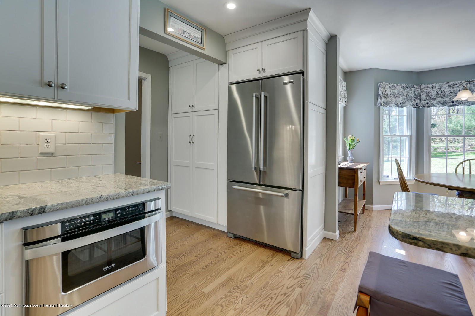 27 Rues Road Cream Ridge, NJ 08514 - Photo 13 of 46 a kitchen with wooden floor and a refrigerator