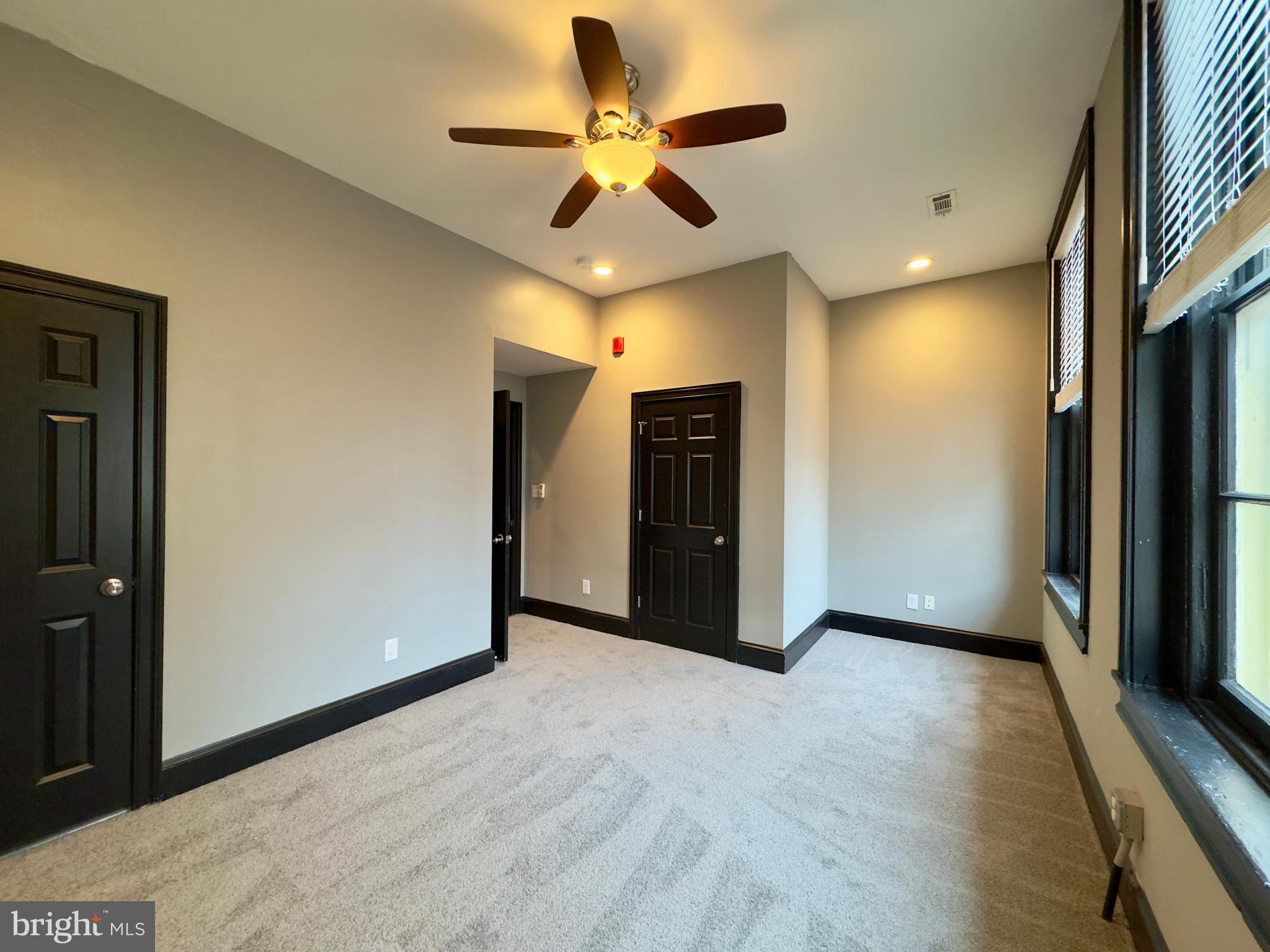 7 West Mulberry Street, Unit 8 Baltimore, MD 21201 - Photo 8 of 18 a view of an empty room and a ceiling fan
