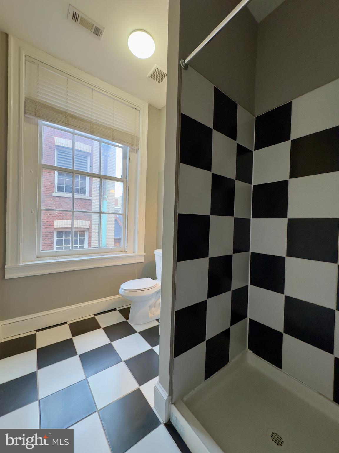 7 West Mulberry Street, Unit 8 Baltimore, MD 21201 - Photo 10 of 18 a black and white checkered floor