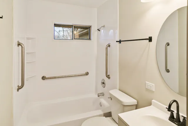 a bathroom with a shower a toilet and a sink