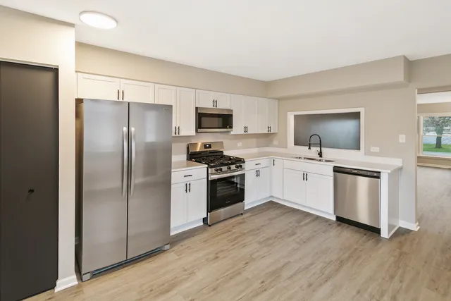 a kitchen with a refrigerator stove and sink