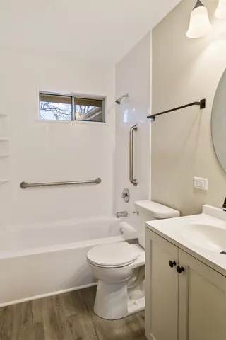 a bathroom with a white toilet sitting next to a bathroom sink and a shower